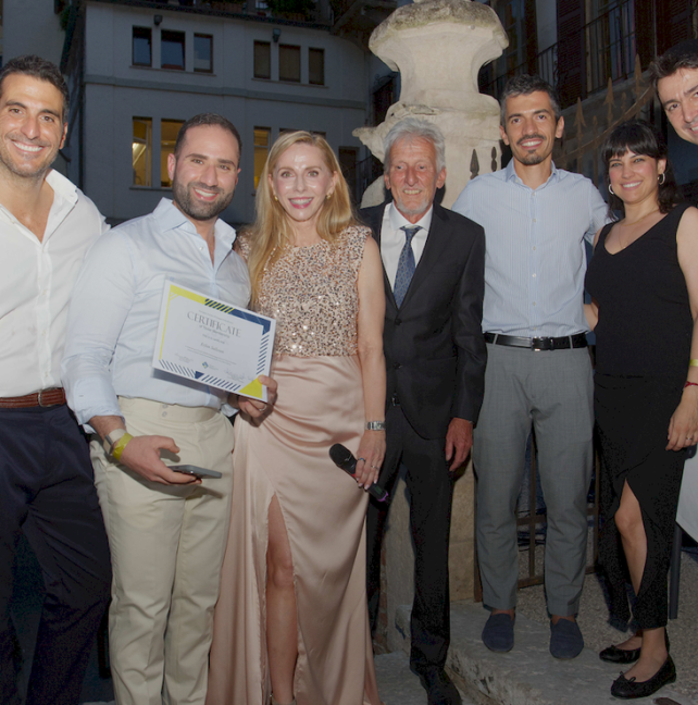 Dr Erfan Salloum holding his ESLO Titular Membership certificate alongside colleagues in Verona, June 2026.